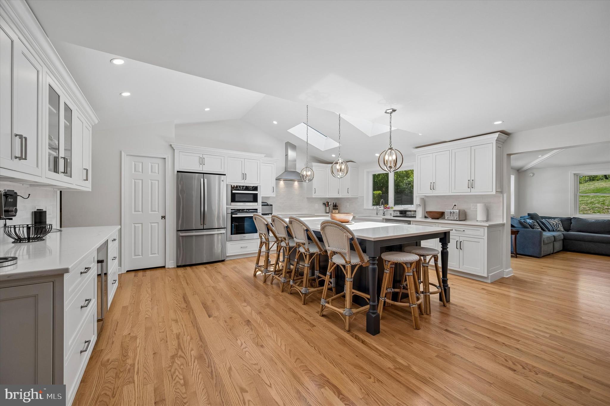 774 Robinhood Road Bryn Mawr, PA 19010 - Photo 7 of 28 a kitchen with stainless steel appliances a dining table chairs stove microwave and cabinets