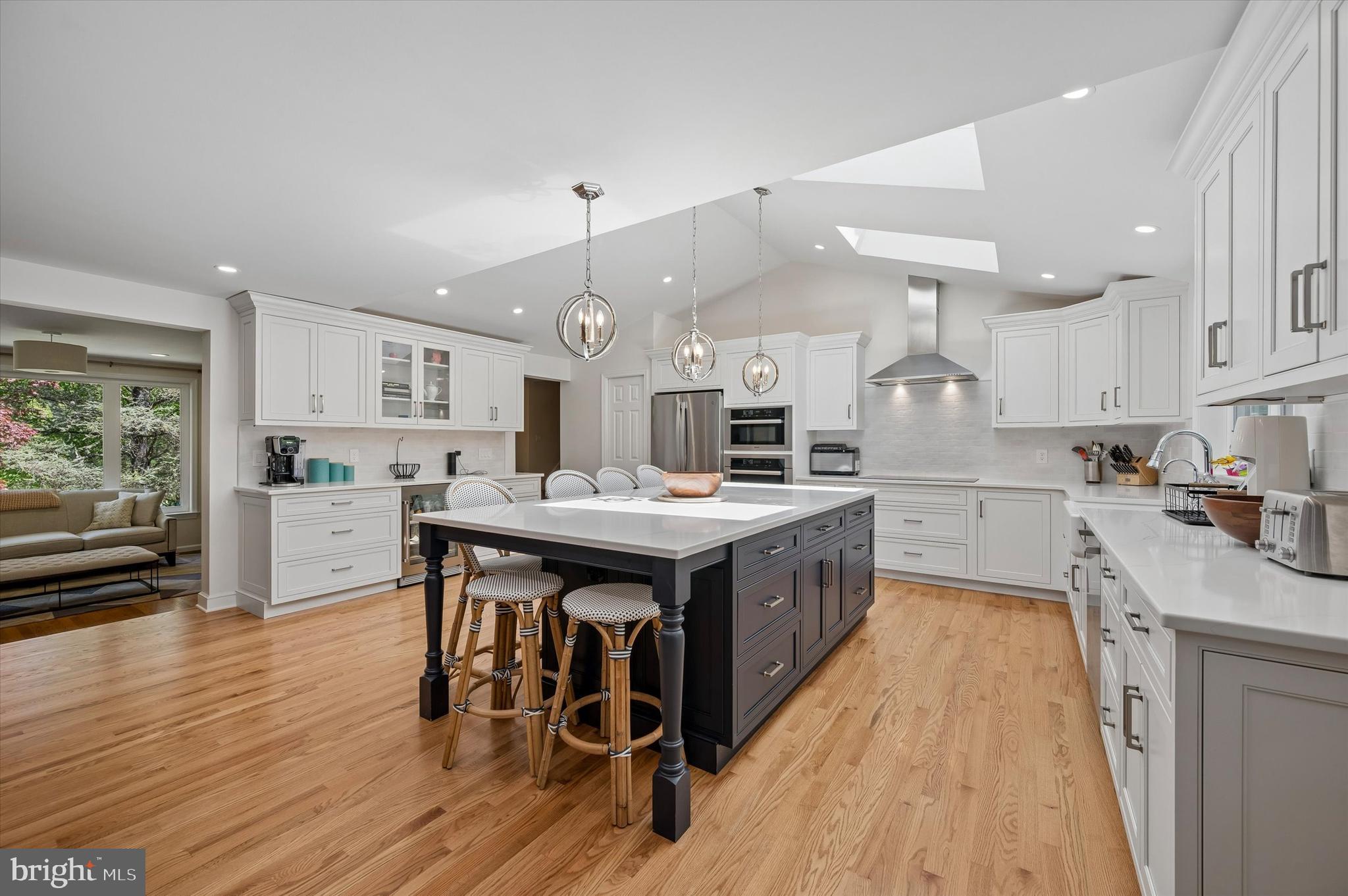 774 Robinhood Road Bryn Mawr, PA 19010 - Photo 8 of 28 a kitchen with stainless steel appliances kitchen island granite countertop a table chairs sink and cabinets