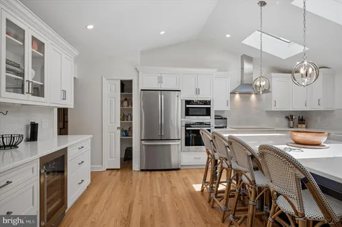 a kitchen with granite countertop a sink appliances a counter space and cabinets