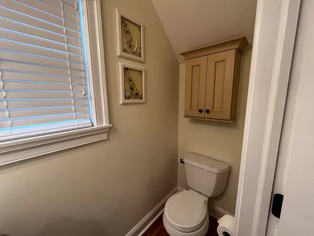 a view of a kitchen with a sink and wooden floor