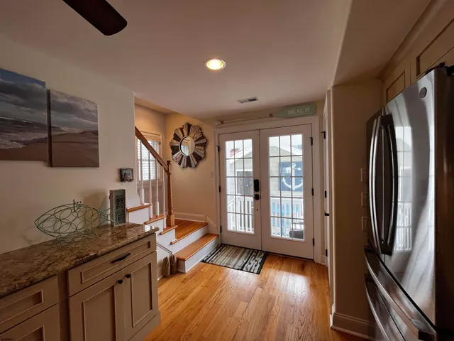 a view of entryway and hall with wooden floor
