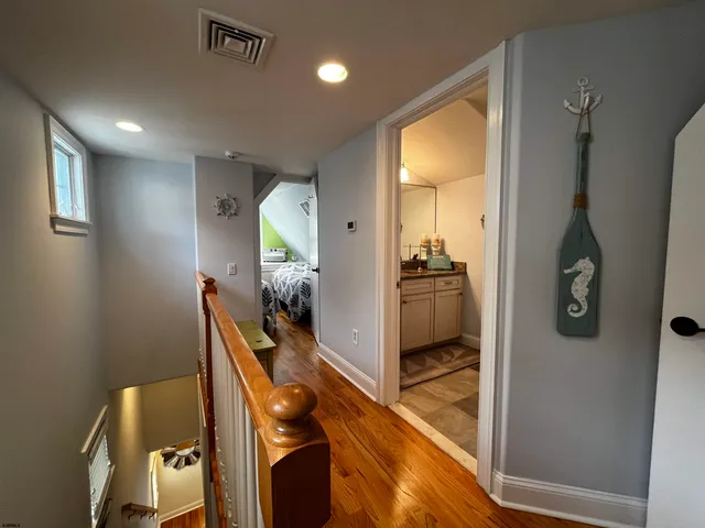 a hallway with front door wooden floor and windows