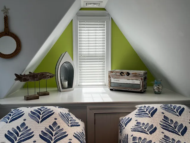 a bedroom with a bed and a lamp on the dresser