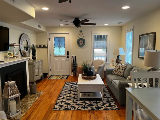 a living room with furniture and a chandelier