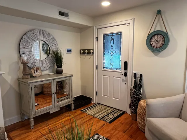 a bedroom with a bed and a chair in it