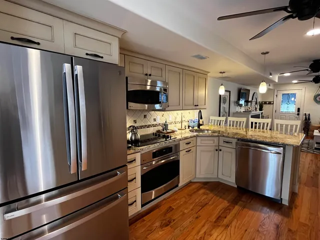 a kitchen with granite countertop a sink and cabinets