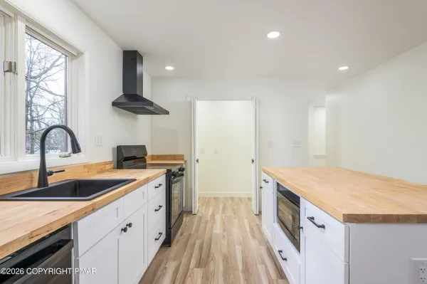 a kitchen with a sink a stove and cabinets