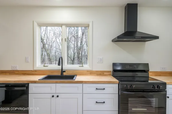 a kitchen with a stove and a window