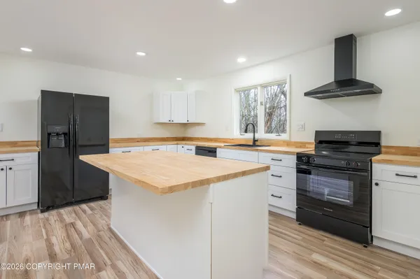 a kitchen with a stove a sink and a refrigerator