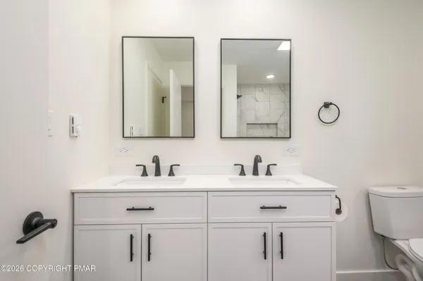 a bathroom with 2 sink and a mirror