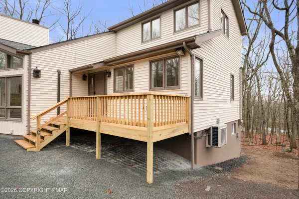 a view of a house with a wooden deck
