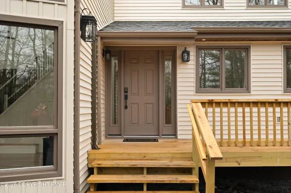 a view of front door of house with stairs