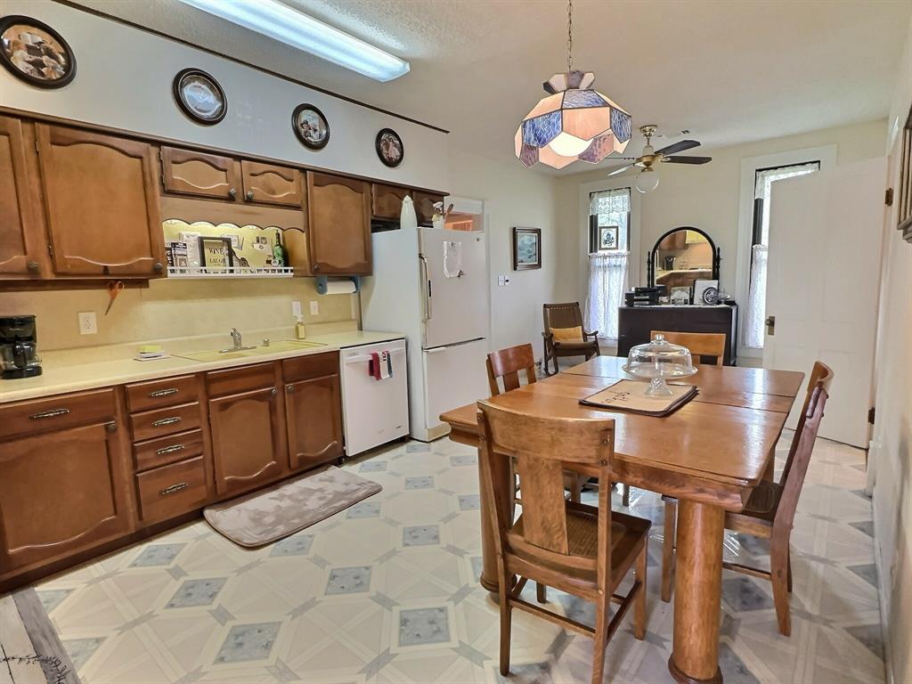 300 South Miller Street Rising Star, TX 76471 - Photo 13 of 39 a kitchen with stainless steel appliances a stove a sink and a refrigerator
