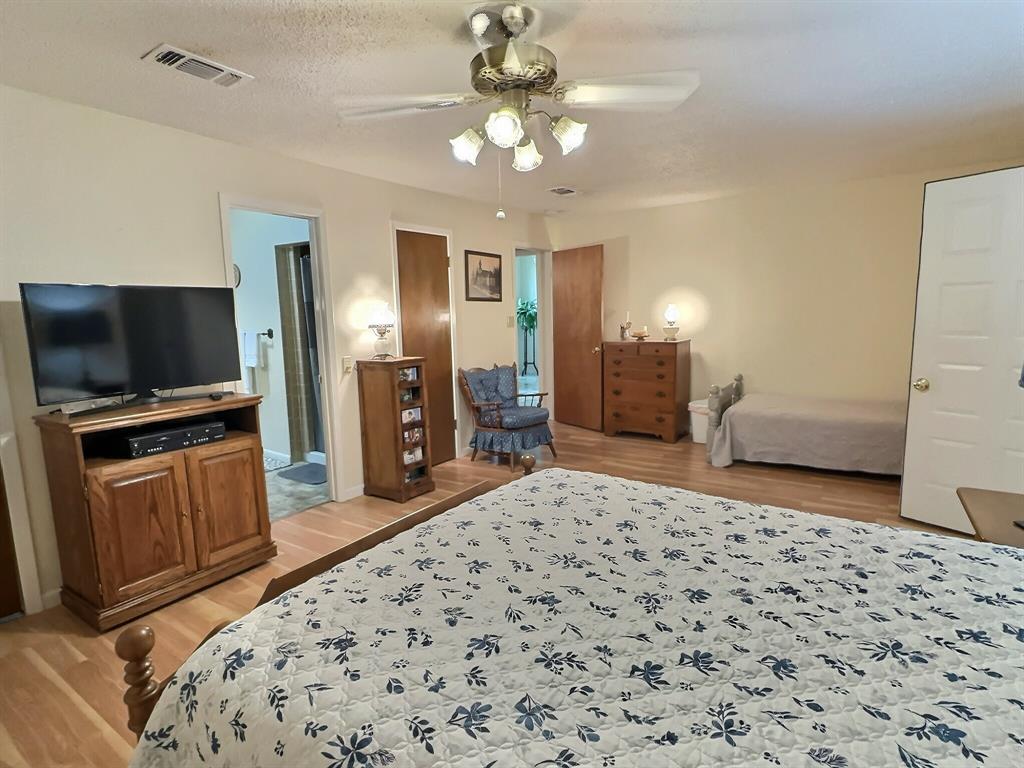 300 South Miller Street Rising Star, TX 76471 - Photo 16 of 39 a bedroom with a bed and a flat screen tv