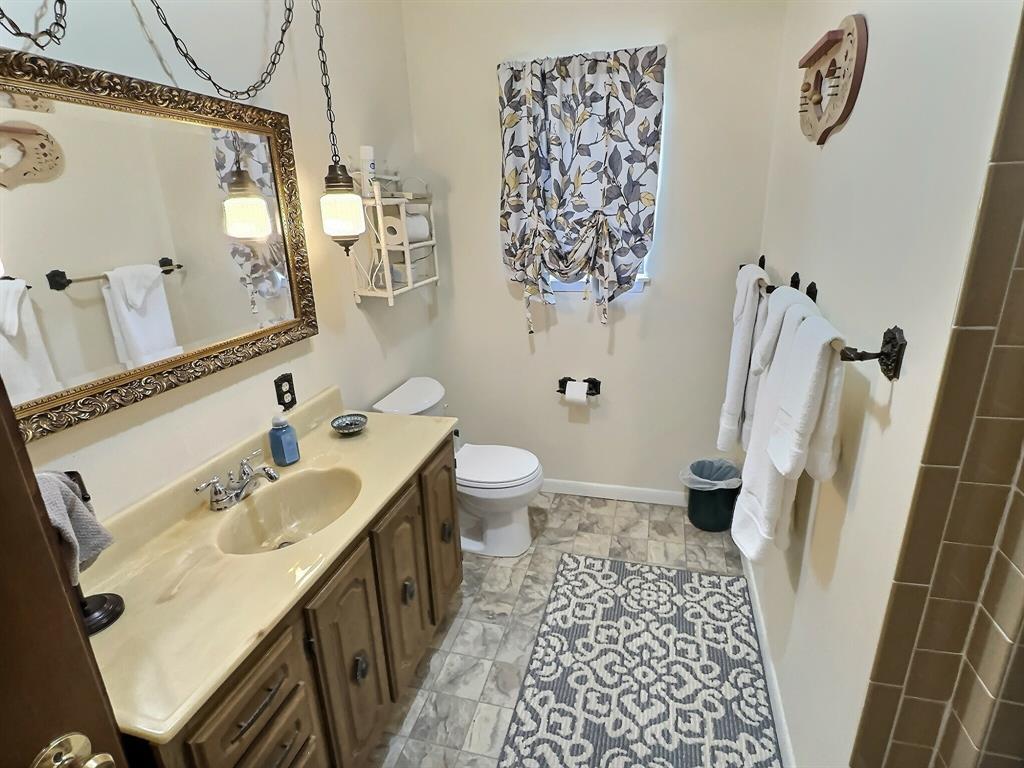 300 South Miller Street Rising Star, TX 76471 - Photo 17 of 39 a bathroom with a sink and a mirror