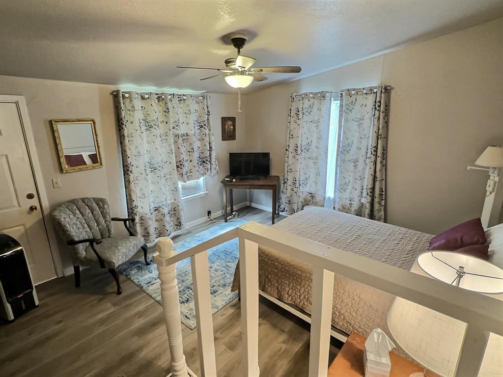 300 South Miller Street Rising Star, TX 76471 - Photo 19 of 39 a spacious bedroom with a bed and a flat screen tv