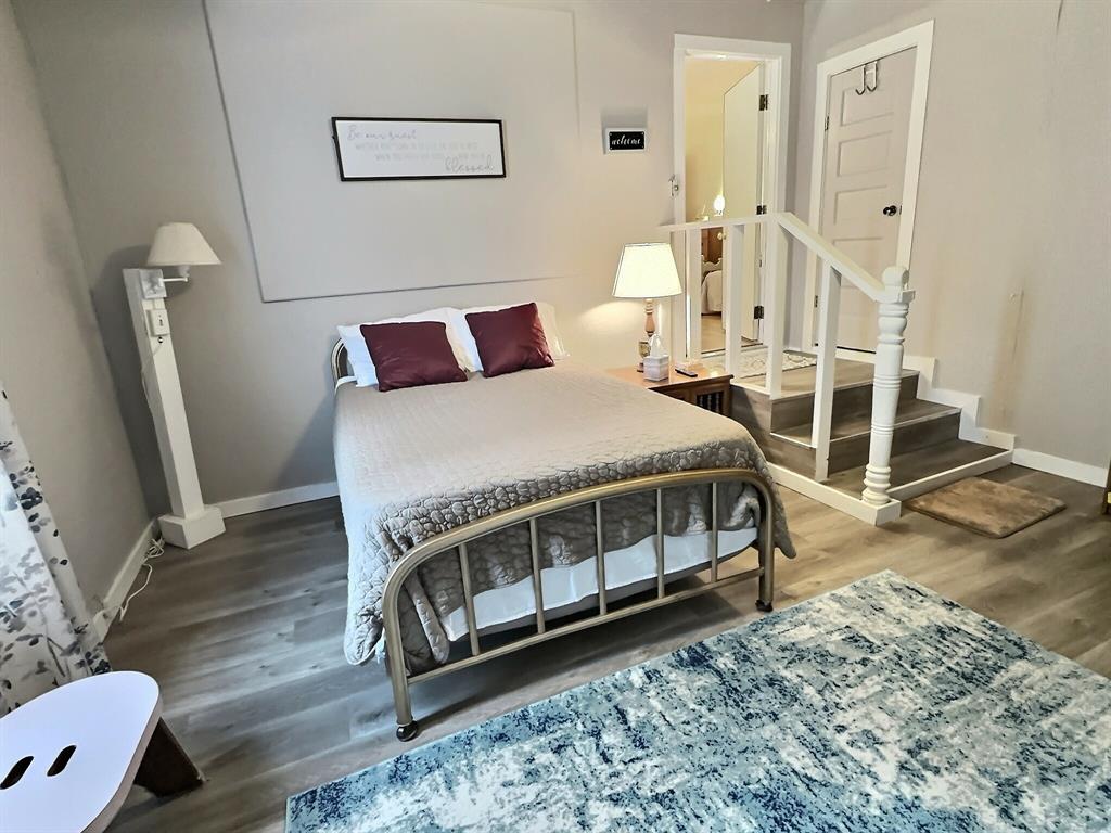 300 South Miller Street Rising Star, TX 76471 - Photo 20 of 39 a bedroom with a bed and wooden floor