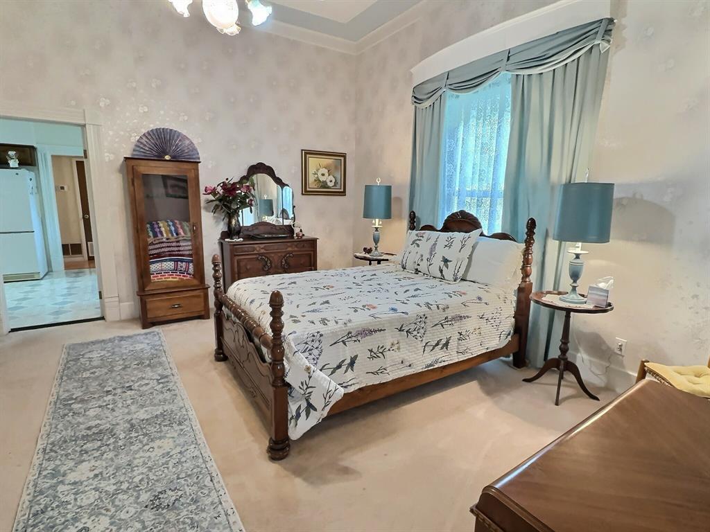 300 South Miller Street Rising Star, TX 76471 - Photo 21 of 39 a bedroom with a bed and a dresser with mirror
