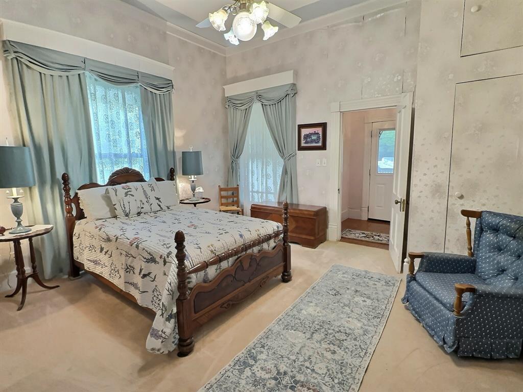 300 South Miller Street Rising Star, TX 76471 - Photo 22 of 39 a bedroom with a large bed a couch and dresser