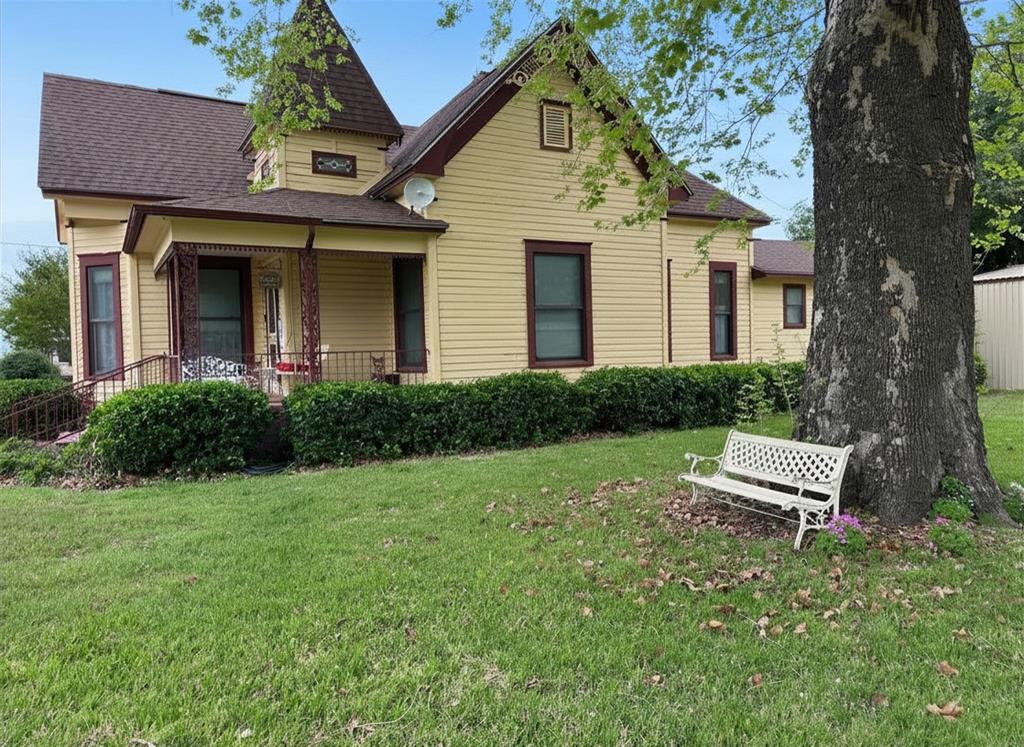 300 South Miller Street Rising Star, TX 76471 - Photo 5 of 39 a front view of a house with a garden