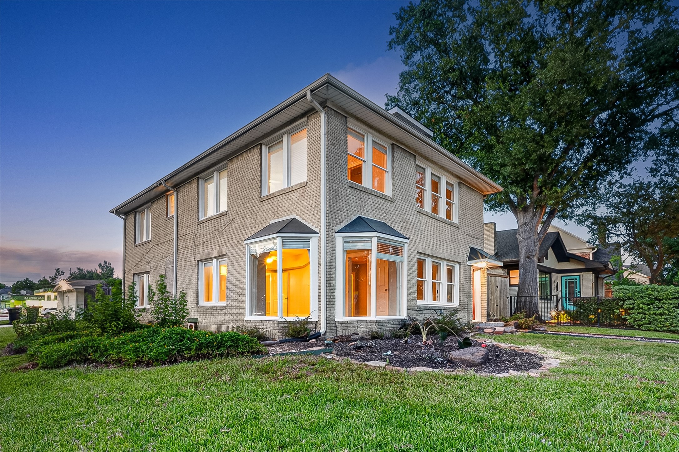 1758 Hawthorne Street, Unit 2 Houston, TX 77098 - Photo 1 of 19 This is a spacious two-story brick home with large windows, offering plenty of natural light. It features well-maintained landscaping and a side entry, set in a neighborhood with mature trees.