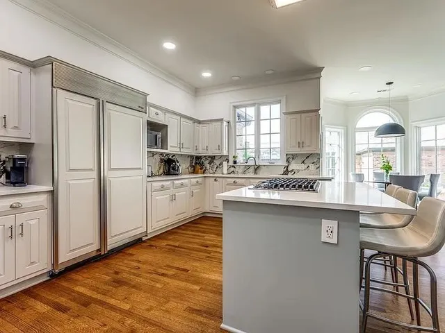 a kitchen with counter top space cabinets and appliances