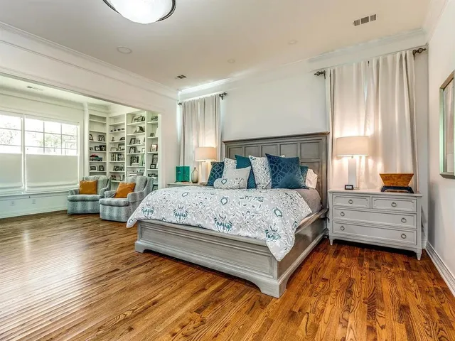 a bedroom with a bed and large window with outer view