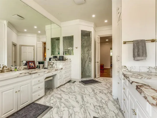 a large bathroom with a sink mirror and a shower