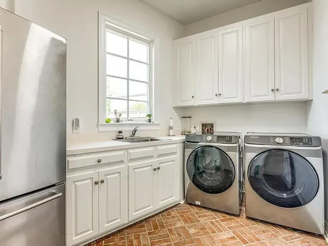 a utility room with sink dryer and washer
