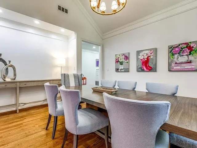 a dining room with furniture and wooden floor