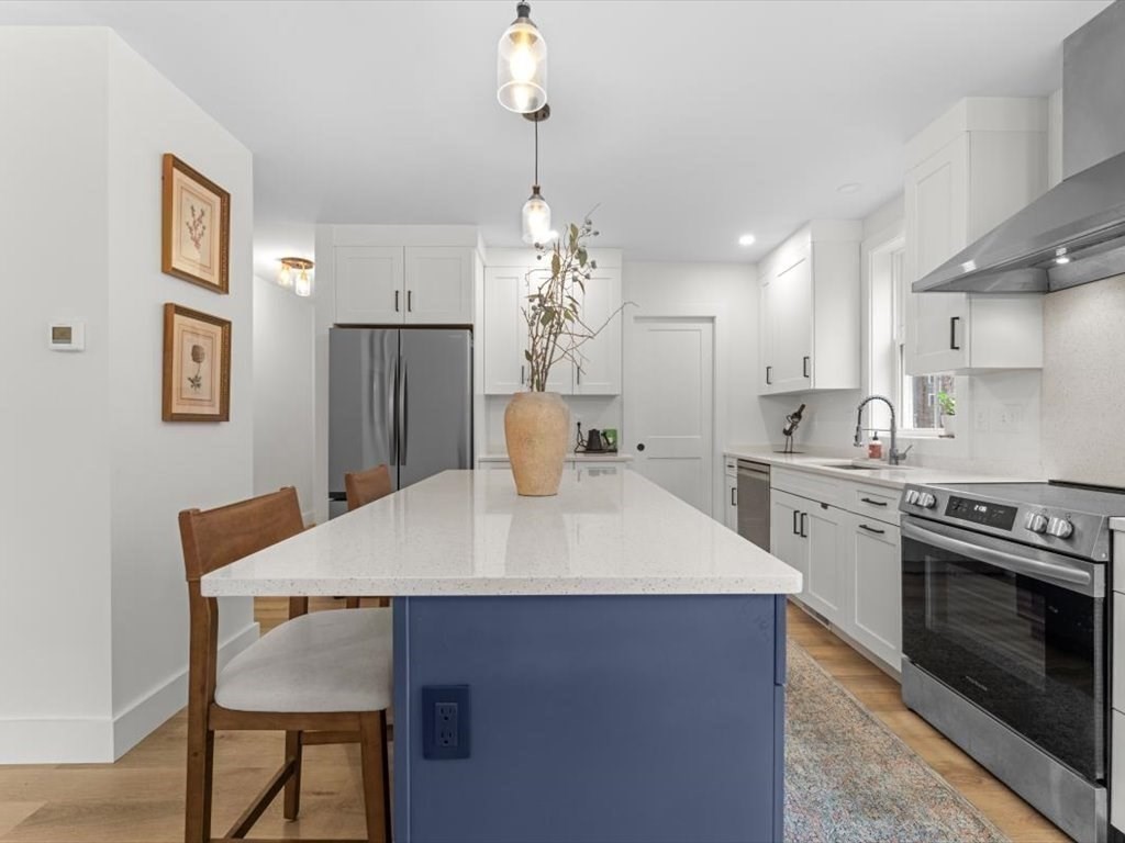 560 Queen Lake Road Phillipston, MA 01331 - Photo 14 of 42 a kitchen with a table chairs stove and refrigerator