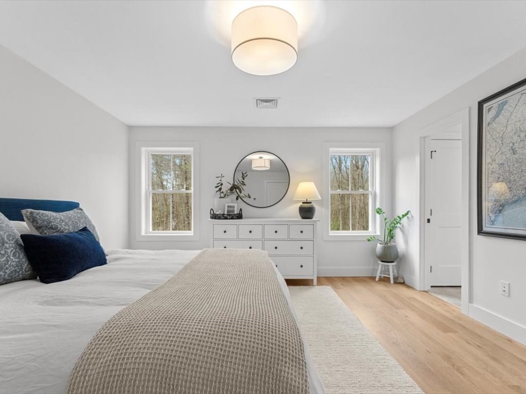 560 Queen Lake Road Phillipston, MA 01331 - Photo 20 of 42 a bedroom with a bed mirror and window