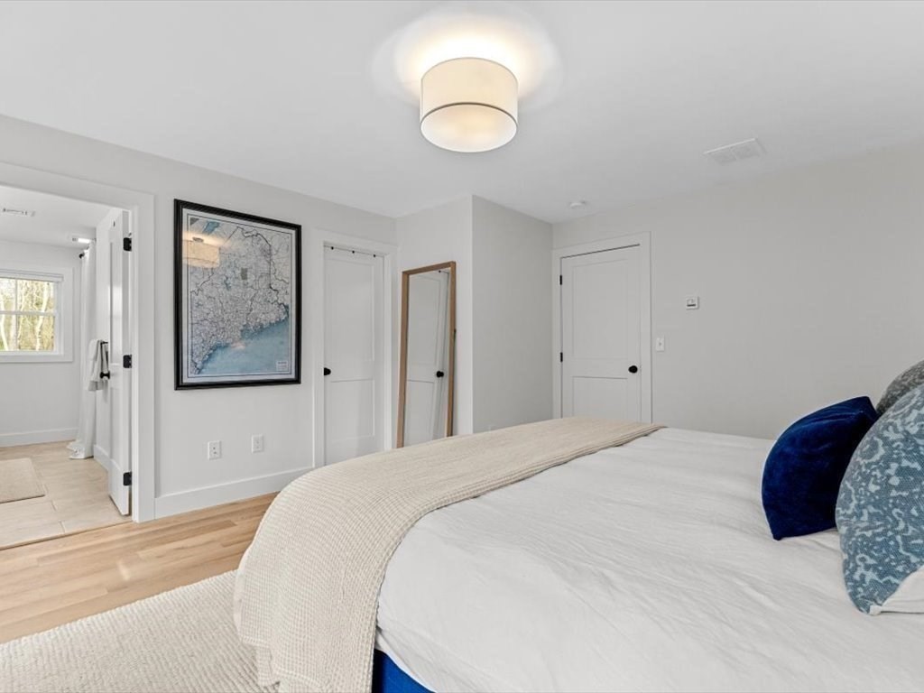 560 Queen Lake Road Phillipston, MA 01331 - Photo 21 of 42 a bedroom with a bed and a painting on the wall