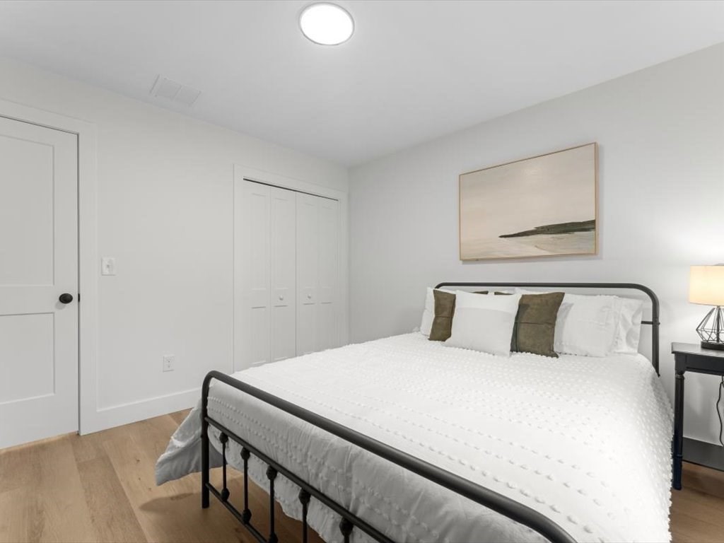 560 Queen Lake Road Phillipston, MA 01331 - Photo 25 of 42 a bedroom with a bed and a painting on the wall
