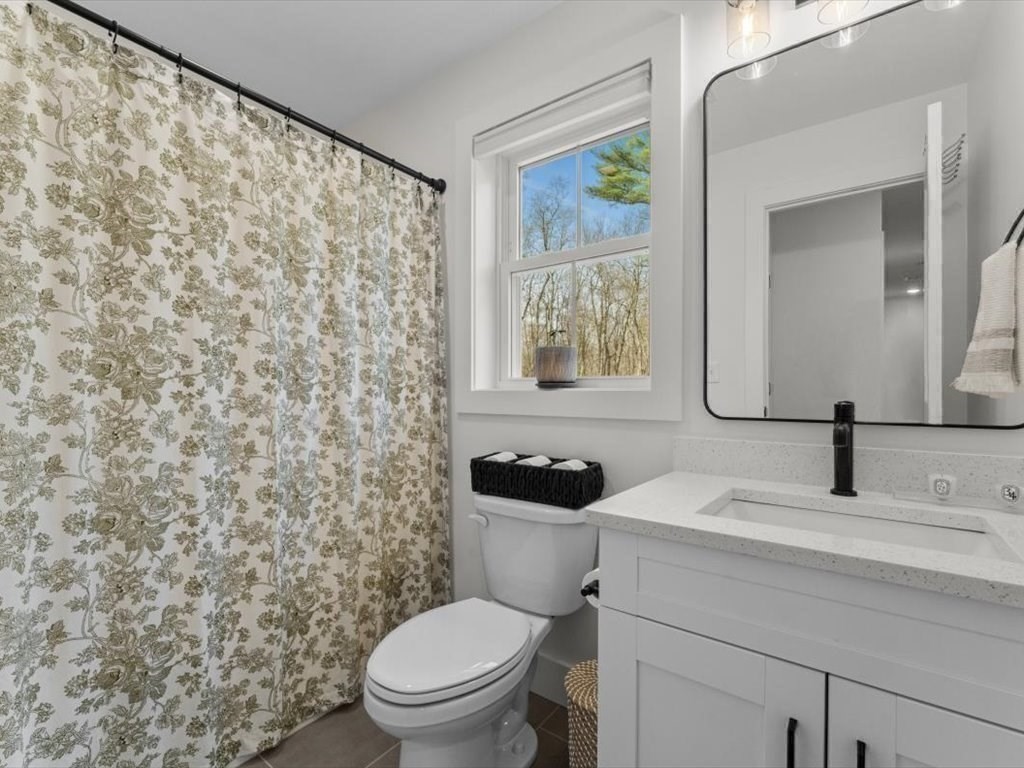 560 Queen Lake Road Phillipston, MA 01331 - Photo 28 of 42 a bathroom with a toilet sink and mirror