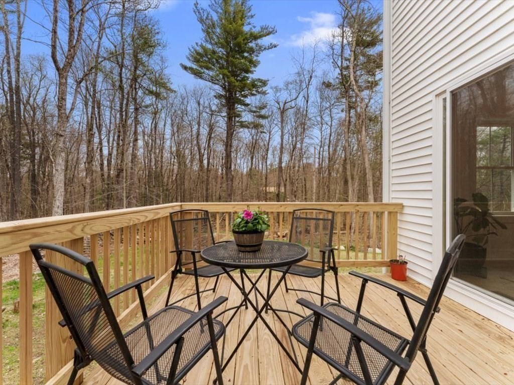 560 Queen Lake Road Phillipston, MA 01331 - Photo 34 of 42 a view of balcony with table and chairs and wooden fence