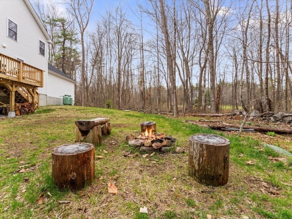 560 Queen Lake Road Phillipston, MA 01331 - Photo 36 of 42 a backyard of a house with table and chairs