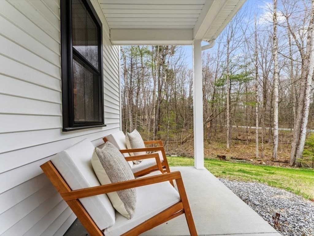 560 Queen Lake Road Phillipston, MA 01331 - Photo 4 of 42 a house view with a sitting space and garden