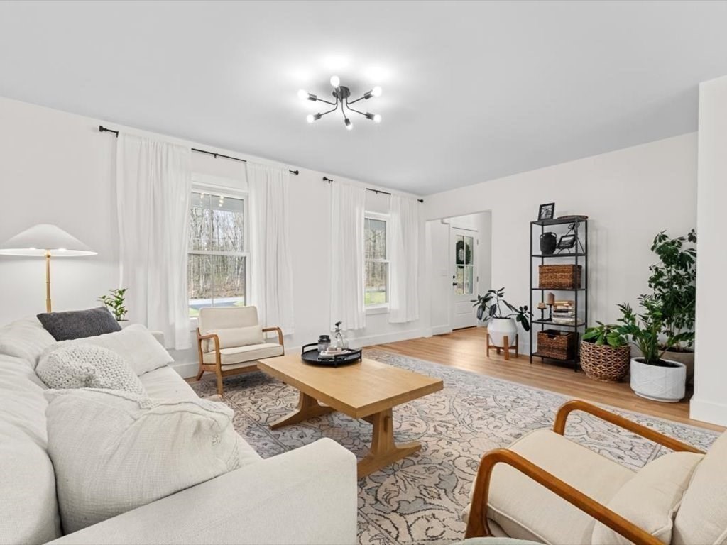 560 Queen Lake Road Phillipston, MA 01331 - Photo 6 of 42 a living room with furniture and a chandelier