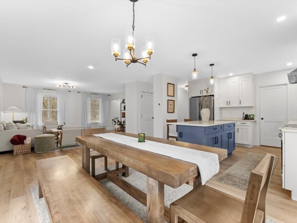 560 Queen Lake Road Phillipston, MA 01331 - Photo 8 of 42 a large bedroom with a large bed and a chandelier