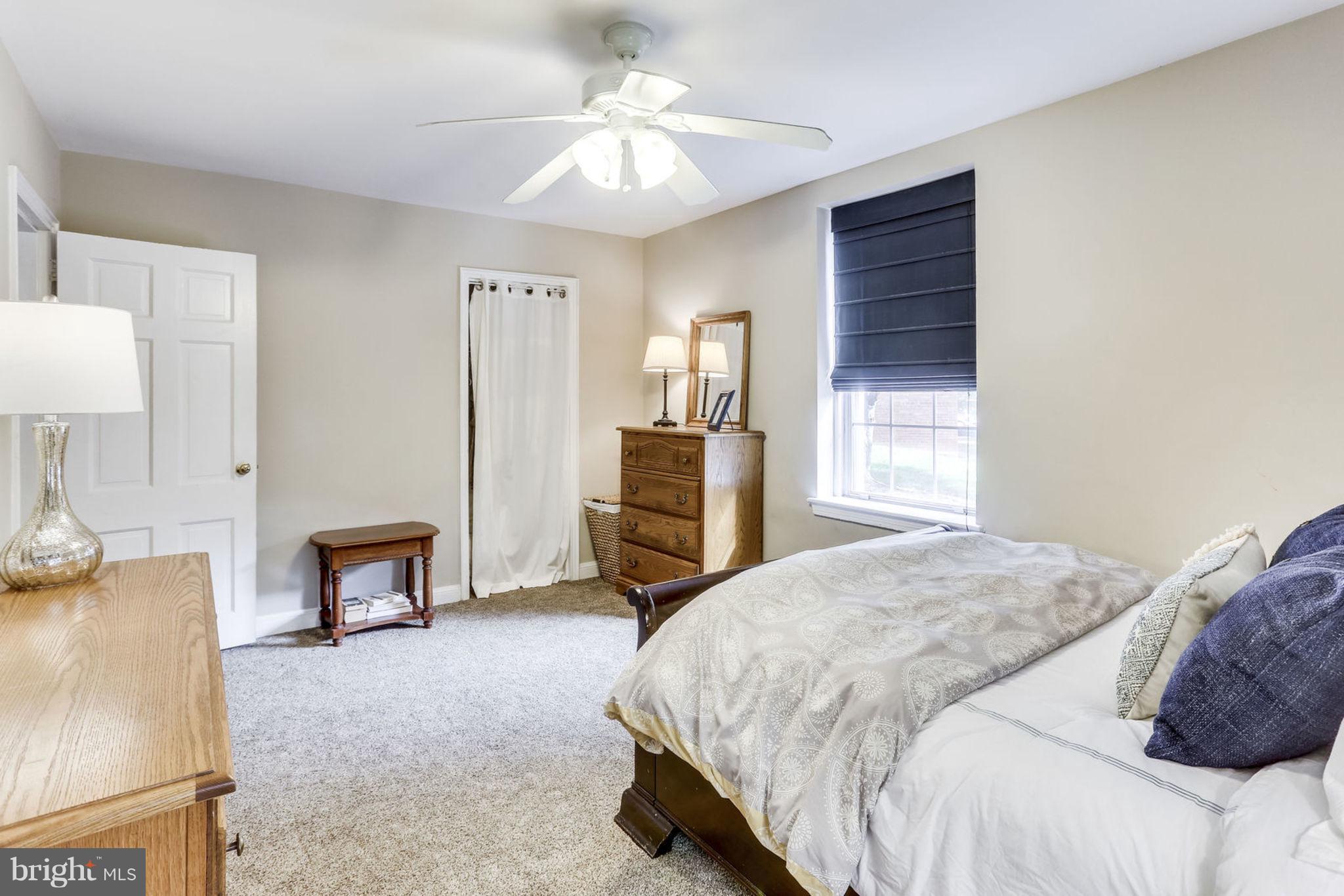 24 South Old Glebe Road, Unit 2C Arlington, VA 22204 - Photo 13 of 24 a bedroom with a bed and a chandelier