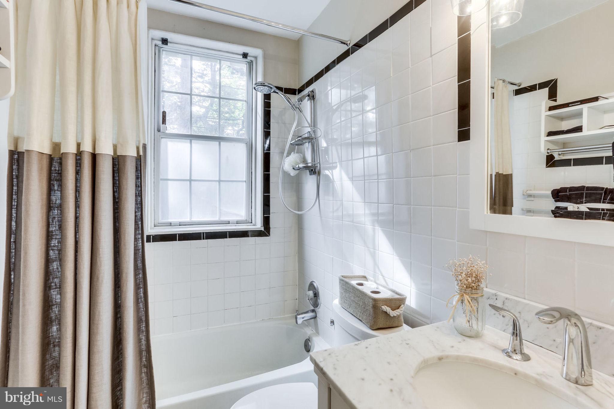24 South Old Glebe Road, Unit 2C Arlington, VA 22204 - Photo 14 of 24 a bathroom with a granite countertop sink and a mirror