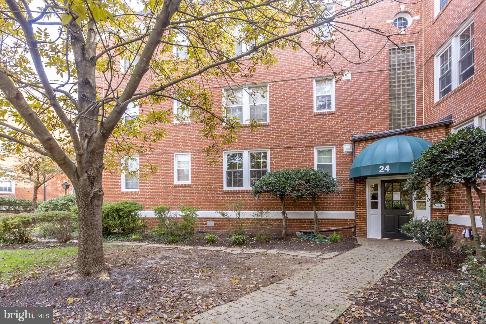 24 South Old Glebe Road, Unit 2C Arlington, VA 22204 - Photo 20 of 24 a front view of a house with a yard and tree s