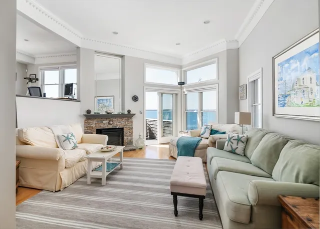 a living room with furniture large window and a fireplace