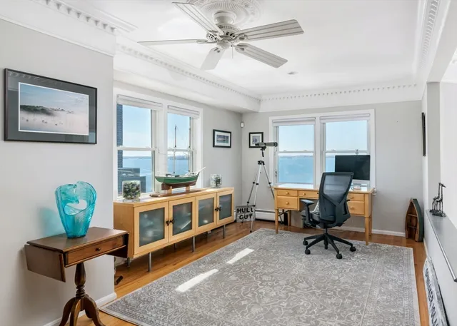 a view of a workspace with furniture and a window