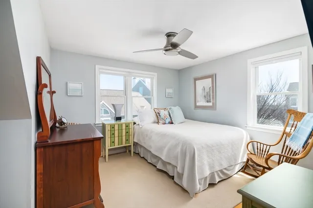 a bedroom with two beds and a dresser