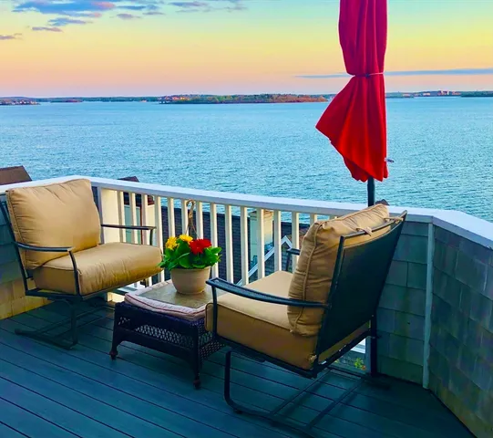 a roof deck with a table and chairs