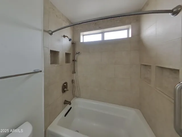 a bathroom with a bathtub and a shower