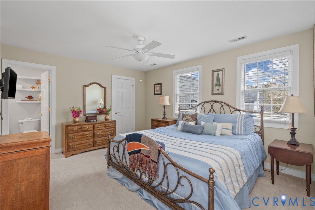 2205 Magnolia Grove Way Midlothian, VA 23113 - Photo 30 of 37 a bedroom with a large bed and a chandelier