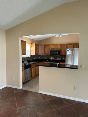 a kitchen with a sink a refrigerator and cabinets